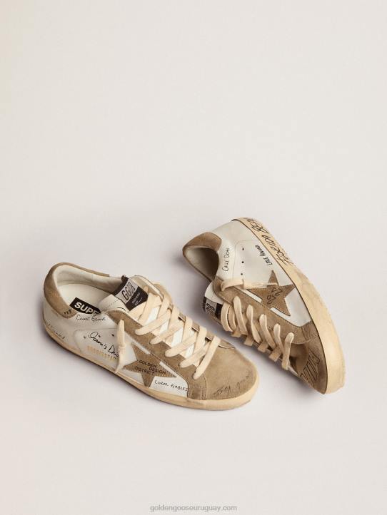 hombres zapatillas super-star de piel blanca con inserciones de ante gris tórtola y letras negras por toda la superficieGolden Goose 02H6511