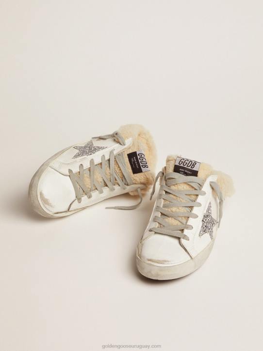 mujer zuecos superestrella de piel blanca con estrella de purpurina plateada y forro de borregoGolden Goose 02H6117